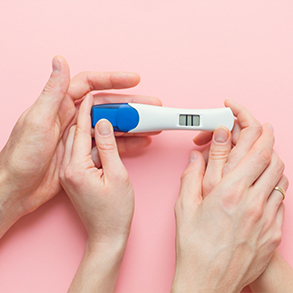 pregnancy-test-with-positive-result-and-clothing-f-PRLJFEC